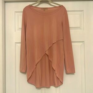 Soft tapered light-pink long-sleeved top.